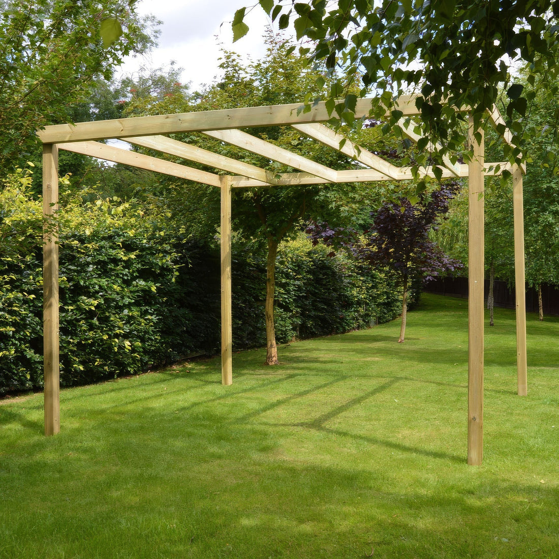 Light green freestanding wooden box pergola in a UK garden