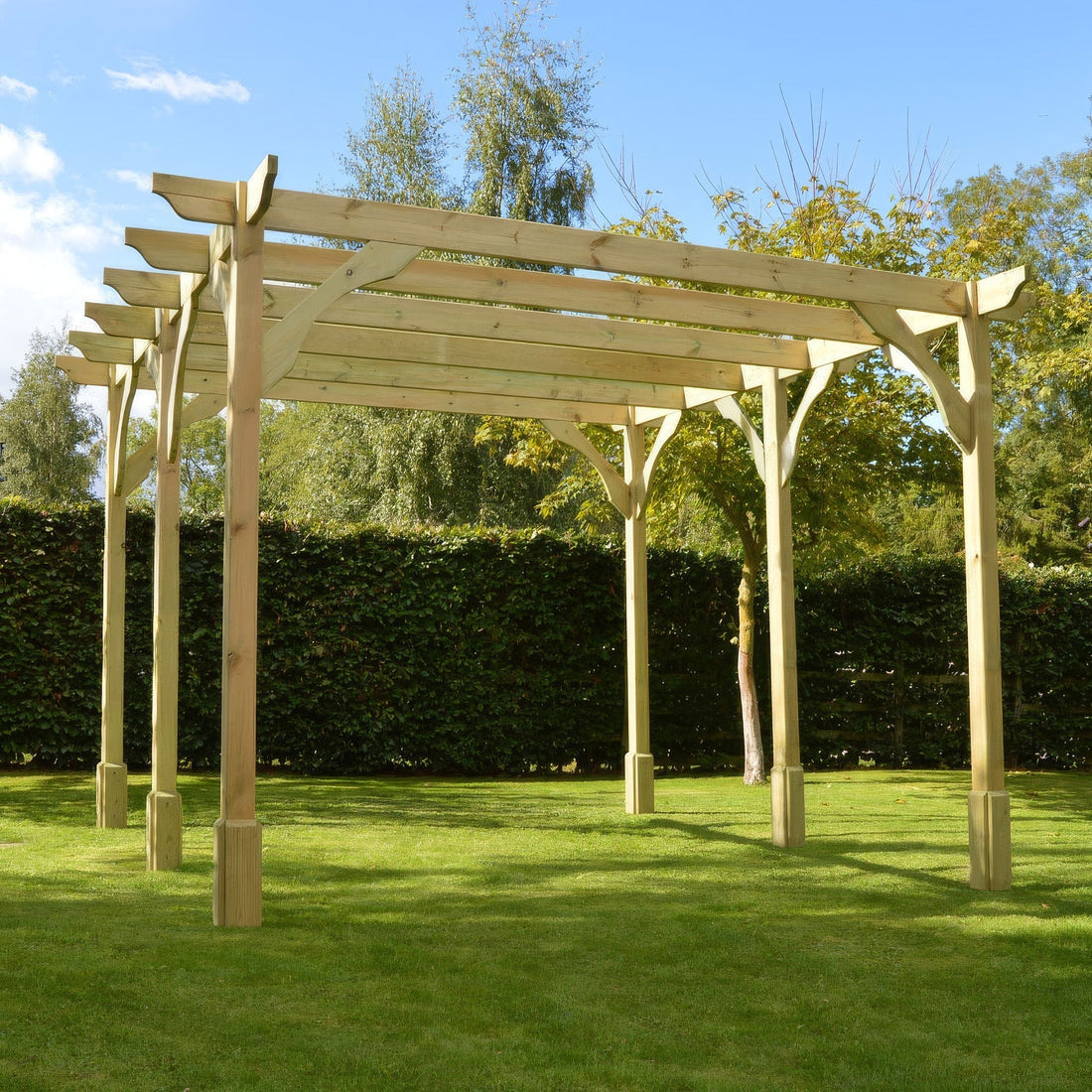 Freestanding timber premium pergola in light green over a garden patio